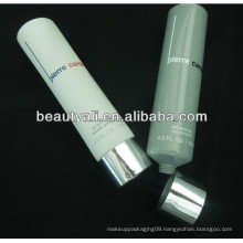 round coloured cosmetic tube with plated cap